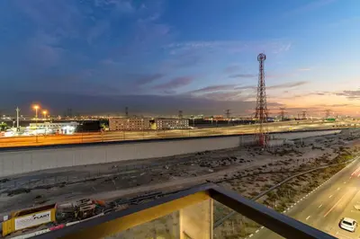 a view of a train station at night at Chic Dubai Studio with Balcony, Pool, Gym, Free Parking Near Expo Metro in Dubai