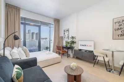 a living room with a bed and a table at Dubai Studio - Trendy Interiors - City Views in Dubai