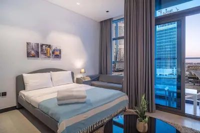 a bedroom with a bed and a view of a city at Lavish Studio at 15 Northside W City Skyline View 3rd floor in Dubai