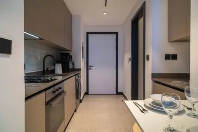 a kitchen with a table with wine glasses on it at Lavish Studio at 15 Northside W City Skyline View 3rd floor in Dubai