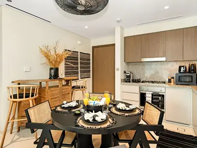a kitchen and dining room with a table and chairs at Ultra-Luxury 2 Bedroom Beachfront Escape with Sea Views in Dubai