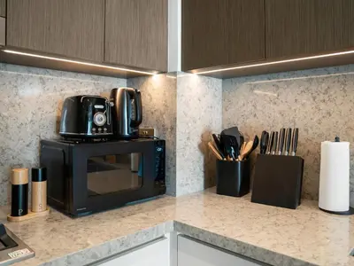 a microwave sitting on top of a kitchen counter at Ultra-Luxury 2 Bedroom Beachfront Escape with Sea Views in Dubai