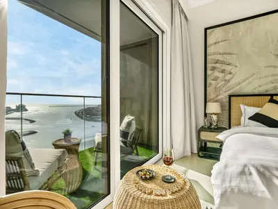 a bedroom with a view of the ocean at Ultra-Luxury 2 Bedroom Beachfront Escape with Sea Views in Dubai