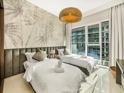 a bedroom with two beds and a large window at Ultra-Luxury 2 Bedroom Beachfront Escape with Sea Views in Dubai