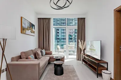 a living room with a couch and a tv at Convenient 1BR apartment in Business Bay in Dubai