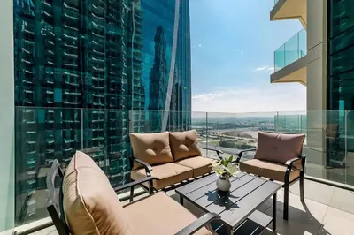 a balcony with two chairs and a table on a building at Convenient 1BR apartment in Business Bay in Dubai