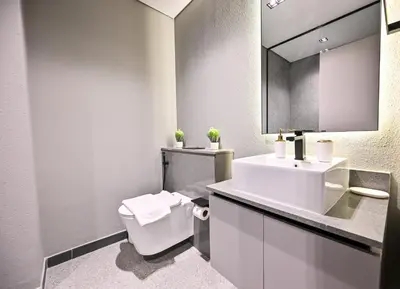 a bathroom with a sink and a toilet and a mirror at Charming Studio in Meydan by Deleguest in Dubai