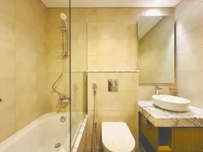 a bathroom with a sink and a toilet and a shower at ايكون ستي 2BEd in Dubai