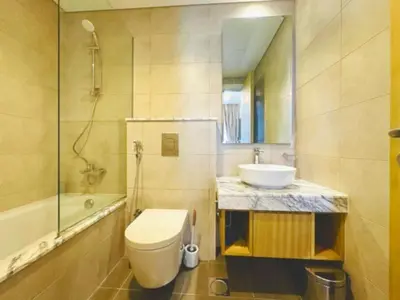 a bathroom with a toilet and a sink at ايكون ستي 2BEd in Dubai