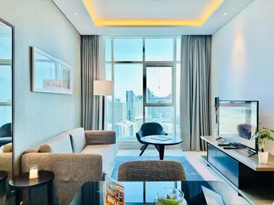 a living room with a couch and a table at Vserve - Stylish specious - 1 Bedroom with Canal View in Dubai