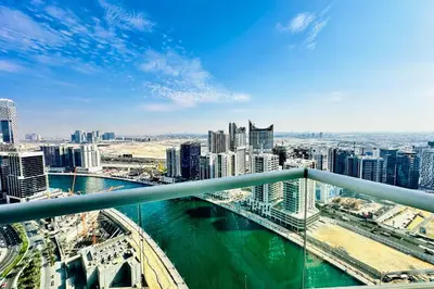 a view of a city with a river and buildings at Vserve - Stylish specious - 1 Bedroom with Canal View in Dubai