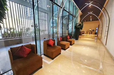 a lobby with couches and chairs in a building at Vserve - Stylish specious - 1 Bedroom with Canal View in Dubai