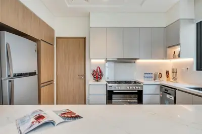 a kitchen with white cabinets and a counter top at Dubai Luxury 4BR Villa in Murooj Al Furjan in Dubai