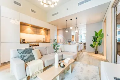 a living room with a white couch and a table at Near Dubai Marina Canal 2BR with Pool and City Views Balcony, Studio One, Dubai Marina by Deluxe Holiday Homes in Dubai