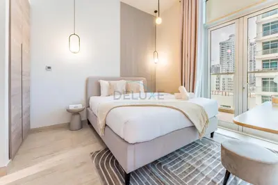 a bedroom with a bed and a large window at Near Dubai Marina Canal 2BR with Pool and City Views Balcony, Studio One, Dubai Marina by Deluxe Holiday Homes in Dubai