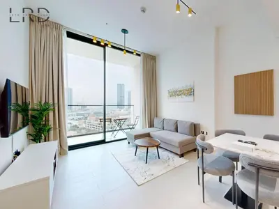 a living room with a couch and a table at Brand New and Modern Smart Home 1BR in Dubai