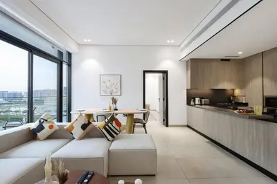 a living room with a couch and a table at Livbnb-Stylish and Spacious 1BR Apartment with Private Balcony in Dubai