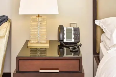 a phone on a night stand next to a bed at Luxury Living At The Address Dubai Marina! in Dubai