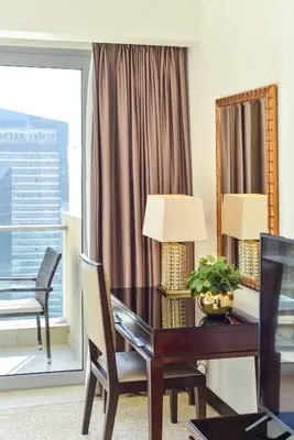 a desk and a chair in a room with a window at Luxury Living At The Address Dubai Marina! in Dubai