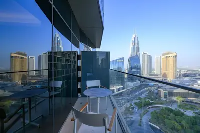 a balcony with chairs and a view of a city at Stylish 3BR Address Opera FULL Burj Khalifa View in Dubai