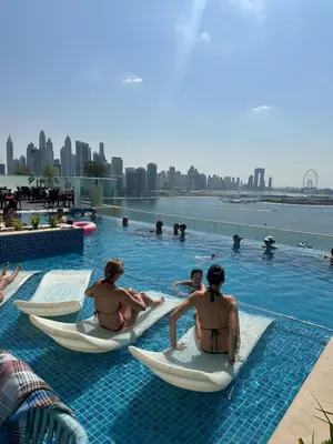 a group of people sitting in kayaks in a pool at Seven Hotel Palm jumeirah in Dubai