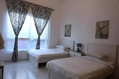 a bedroom with two beds and a window at Nice Place in Dubai