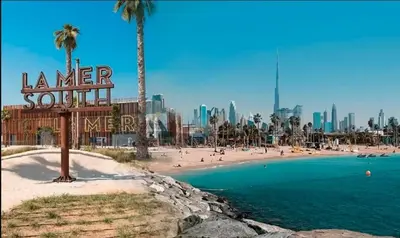 a beach with a sign that reads summer southveltvelt at Nice Place in Dubai