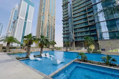 a swimming pool in a city with tall buildings at GuestReady - Marina Gate Studio Suite in Dubai
