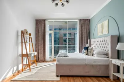 a bedroom with a bed and a large window at GuestReady - Modern living in Downtown Dubai in Dubai