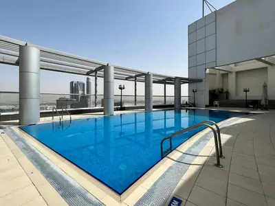 a large swimming pool on the roof of a building at GuestReady - Modern living in Downtown Dubai in Dubai