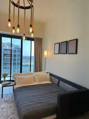 a bedroom with a bed and a large window at Azizi Riviera 44 in Dubai