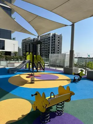 a childrens playground with a slide and a skateboard at Azizi Riviera 44 in Dubai