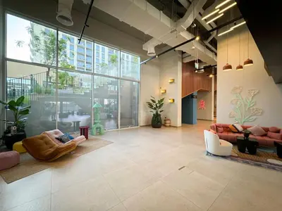a lobby with couches and chairs in a building at Urbane 1BR in Dubai Hills in Dubai