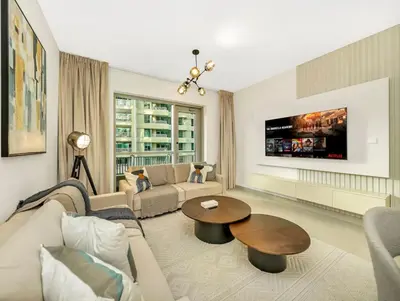 a living room with a couch and a table at Stylish 1BR - Burj Khalifa View in Dubai