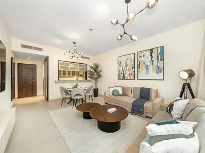 a living room with a couch and a table at Stylish 1BR - Burj Khalifa View in Dubai