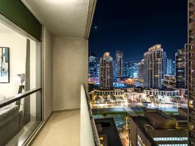 a room with a view of a city at night at Stylish 1BR - Burj Khalifa View in Dubai