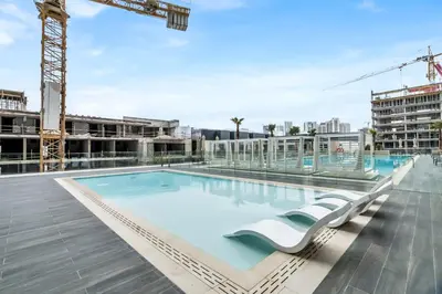 a swimming pool on the roof of a building at Lovely 1BR flat wBalcony Gym & Pool in JVC in Dubai
