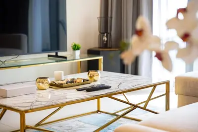 a coffee table in a living room with a table at Rooftop Lounge - Walk to Dubai Mall & Burj Khalifa - Downtown in Dubai