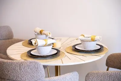 a table with plates and cups on top of it at Rooftop Lounge - Walk to Dubai Mall & Burj Khalifa - Downtown in Dubai