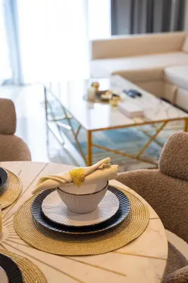 a bowl on a table with a napkin on it at Rooftop Lounge - Walk to Dubai Mall & Burj Khalifa - Downtown in Dubai