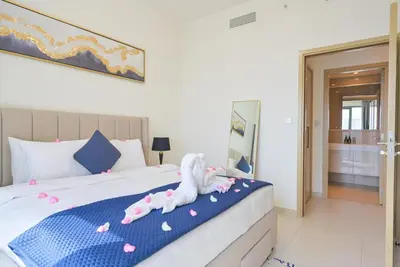 a bedroom with a bed with two stuffed animals on it at Rooftop Lounge - Walk to Dubai Mall & Burj Khalifa - Downtown in Dubai