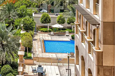 an overhead view of a swimming pool next to a building at The Views & Greens - Mosela Tower, Dubai in Dubai