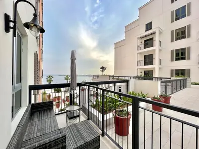 an apartment balcony with a view of the ocean at 50 Shades of Grey Luxury Apartment near Beach in Dubai