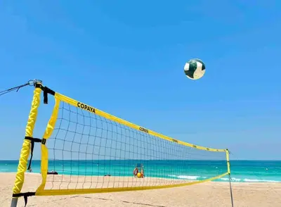 a volleyball net on a beach with a ball at 50 Shades of Grey Luxury Apartment near Beach in Dubai