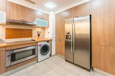 a kitchen with a stainless steel refrigerator and a dishwasher at Glance at the Royal Atlantis Right by Dubai Top Spots 2BR, Marina Apartments 3, Palm Jumeirah by Deluxe Holiday Homes in Dubai