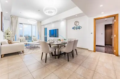 a dining room and living room with a table and chairs at Glance at the Royal Atlantis Right by Dubai Top Spots 2BR, Marina Apartments 3, Palm Jumeirah by Deluxe Holiday Homes in Dubai