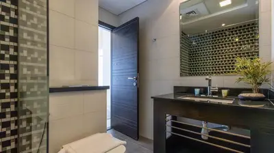 a bathroom with a sink and a mirror at Breathtaking Marina 2BR in Iconic Cayan Tower - 7AB08 in Dubai