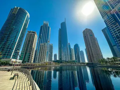 a city skyline with tall buildings and a body of water at Higuest - Lake-view Studio in JLT in Dubai