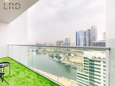 a balcony with a view of a river at Elegant 1BR with Stunning Canal Views in Dubai