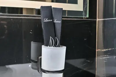 a cup with utensils in it on a counter at Stunning 1 Bdr luxury residence at JVC in Dubai